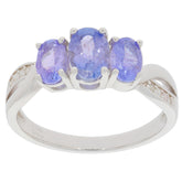 Oval blue tanzanite sterling silver ring with three gemstones, showcasing luxury and elegance.